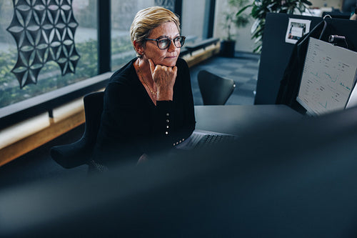 Thoughtful senior businesswoman at her desk