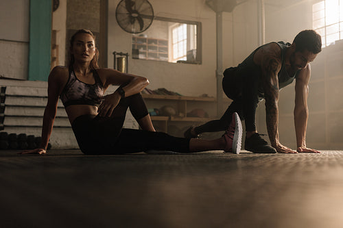 Fitness people doing stretching warmup at gym
