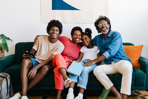Happy Brazilian family relaxing together at home on the sofa