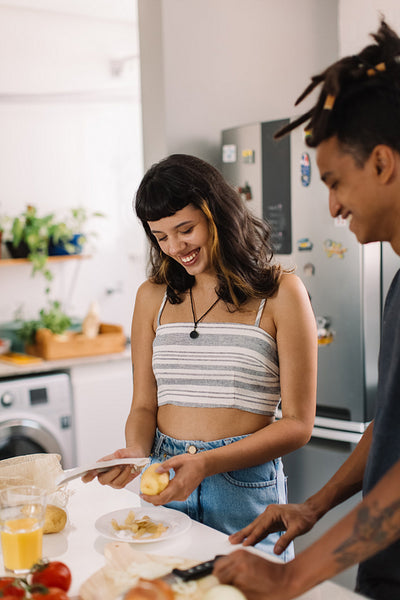 Carefree couple cooking together at home