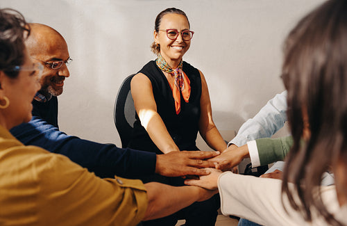 Diverse group of coworkers collaborating in a teamwork exercise with enthusiasm