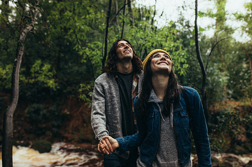 Couple enjoying in forest on a rainy day