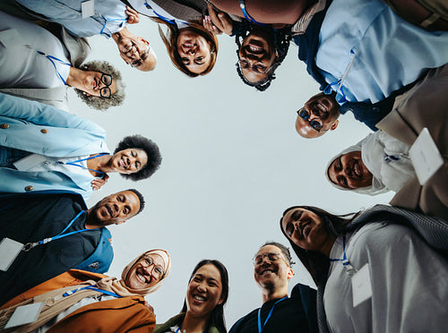 Company staff team smiling together in a huddle