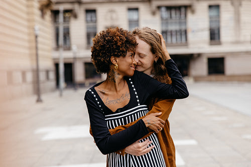 Affectionate embrace on a city street by a loving couple
