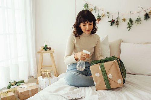 Woman sanitising her christmas gift box
