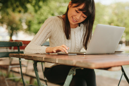 Female using mobile phone at coffee shop