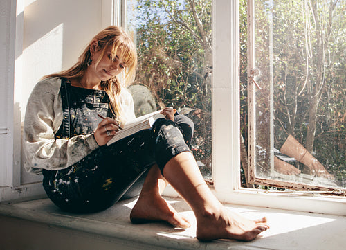 Woman artist drawing in workshop