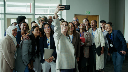 Happy colleagues taking a group selfie