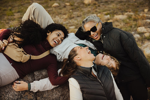 Friends laughing outdoors on a hike