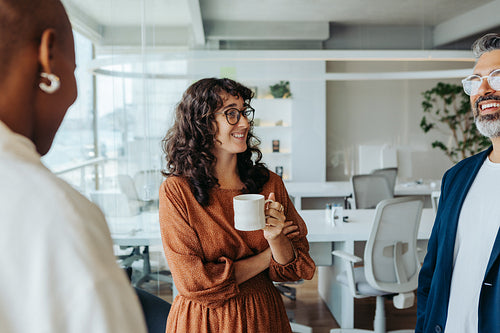 Modern office with business professionals having a creative brainstorming session over coffee