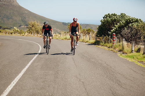 Cyclist riding bikes on open road