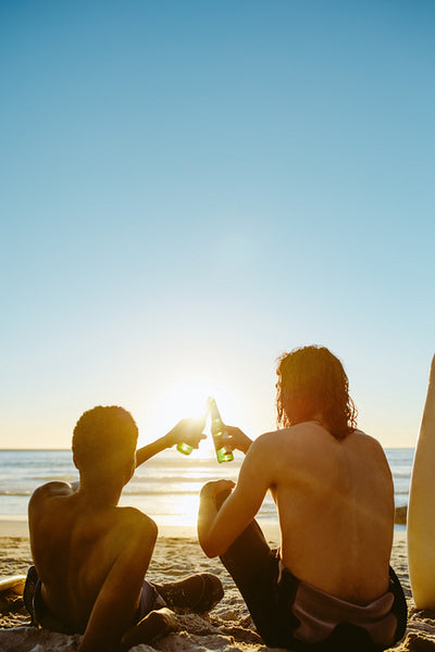 Surfers having beers on the beach