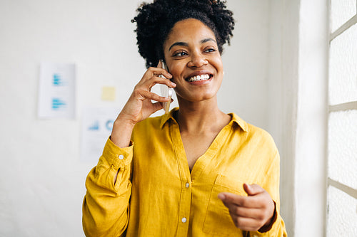 Business woman engaging in a phone call with her colleagues