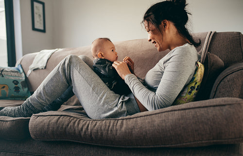 Mother spending time talking to her baby at home