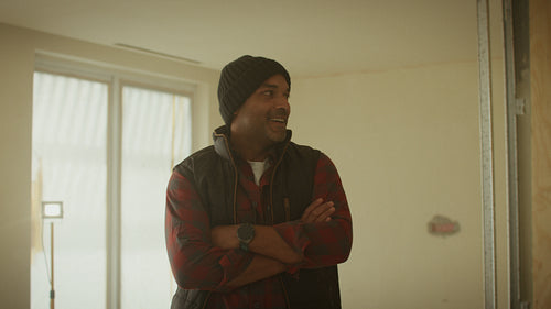 Building the dream: Man smiling during home renovation