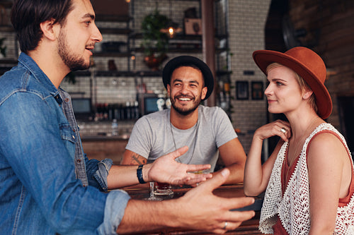 Group of young friends hanging out at a cafe