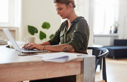 Businesswoman working on laptop at home office