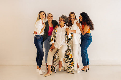 Successful female entrepreneurs laughing happily in a modern off