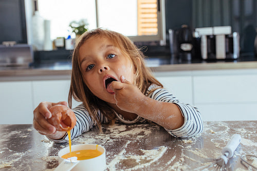 Cute little girl baking in the kitchen