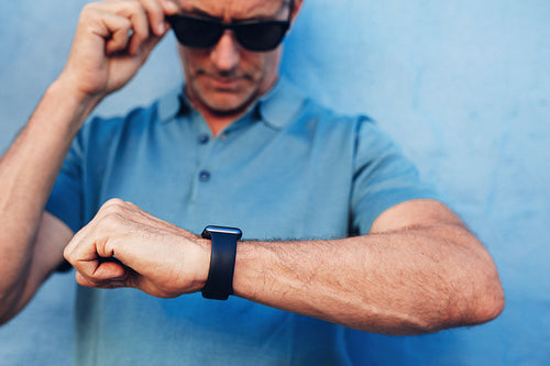 Mature man checking time on his wristwatch