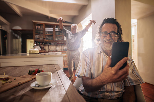 Elderly men having fun at home