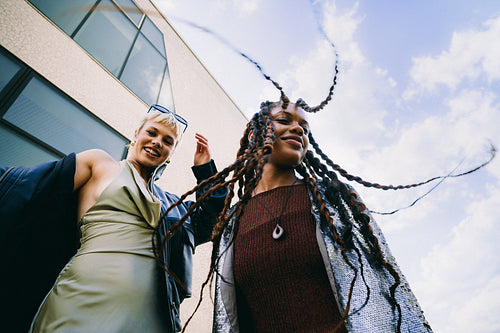 Young friends dance and smile together in the city
