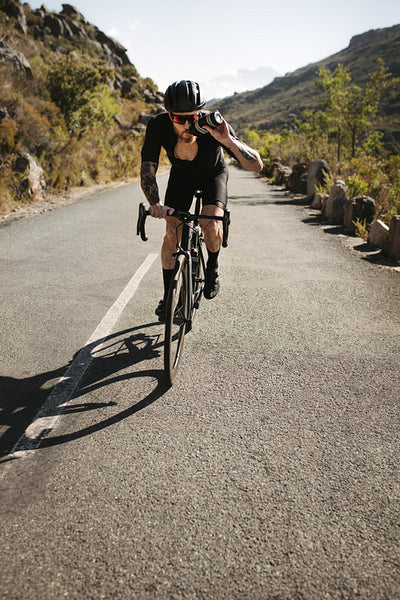 Cyclist getting hydrated while riding