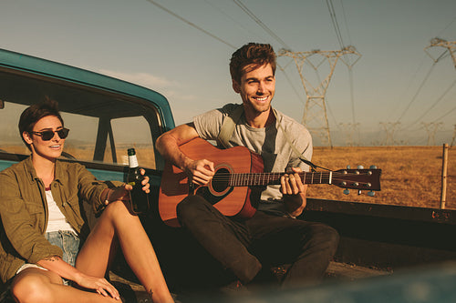 Couple enjoying on a road trip in their car