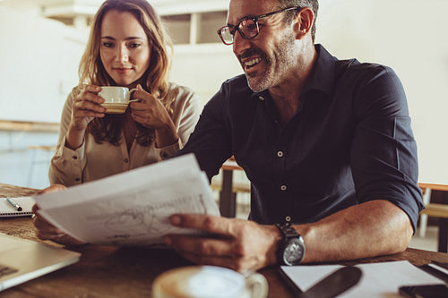 Two business colleagues working at coffee shop