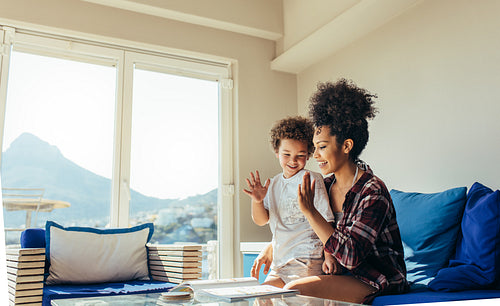 Mother and son having fun reading a book