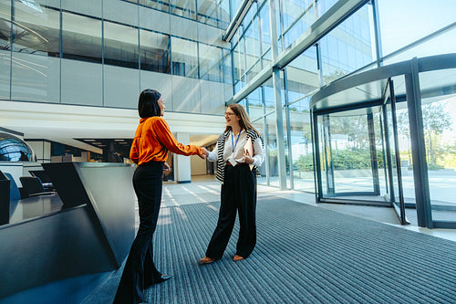 Welcome meeting for new hire in modern office lobby