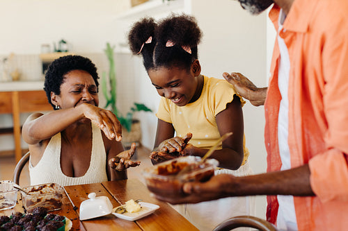 Girl making traditional Brazilian brigadeiro with her parents at home