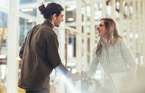 Business partners shaking hands after a meeting