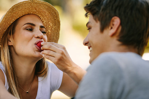 Couple on picnic sitting in park