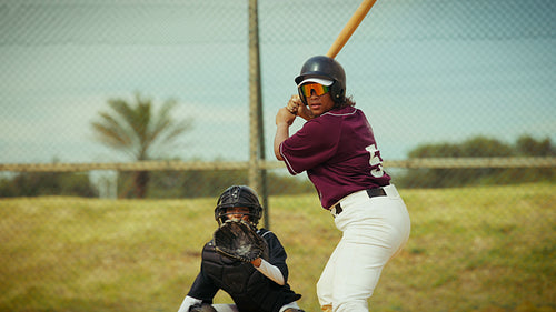 Determined batter connects with the pitch on the field