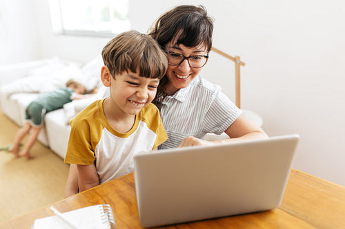 Happy young family using laptop at home