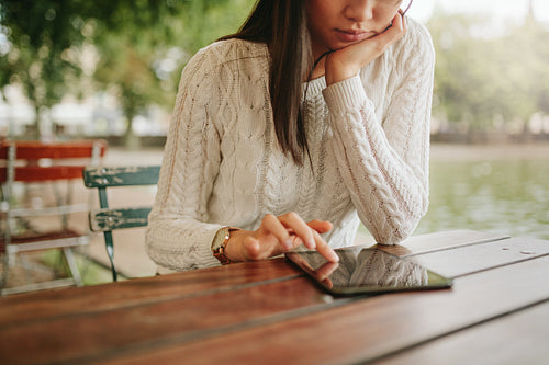 Woman browsing website pages on touch pad