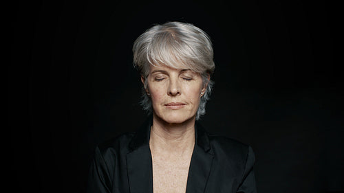 Woman in formal wear with eyes closed