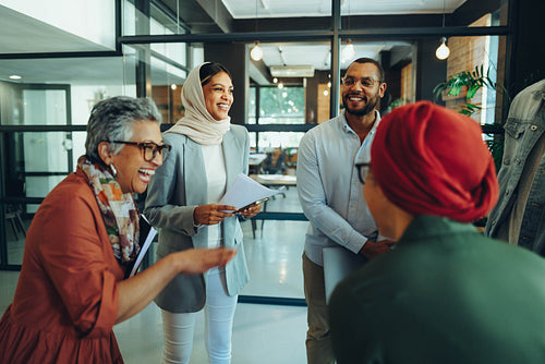 Group of happy businesspeople laughing cheerfully in an office