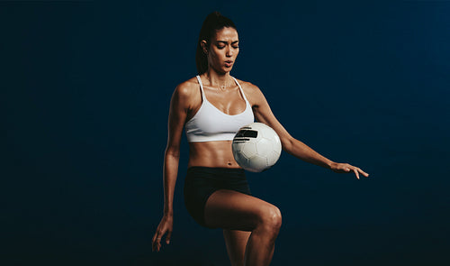 Female footballer concentrating on juggling techniques