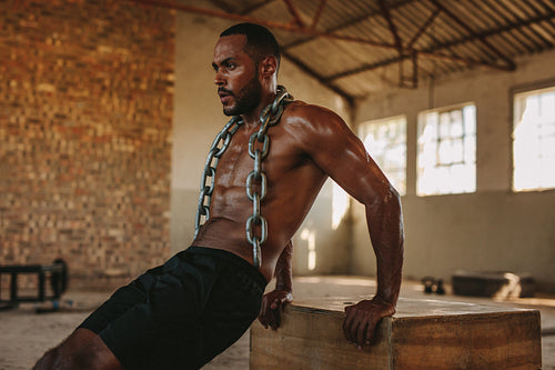 Muscular man doing triceps dips exercise