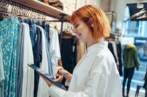 Woman in boutique with digital tablet