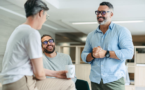 Cheerful businesspeople having a discussion in a modern office