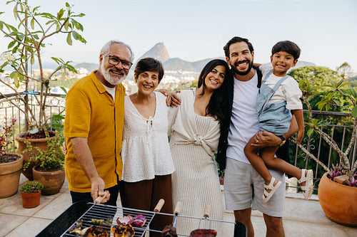 Latin family enjoying a Brazilian churrasco with scenic views in the background
