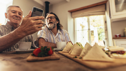Senior men making a video chat on smartphone