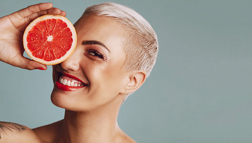 Beautiful woman holding a grapefruit