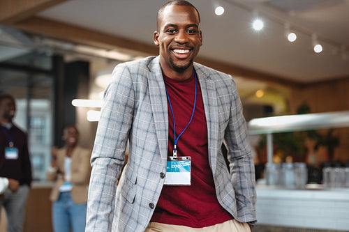 Successful business man taking part in a networking event at a conference venue