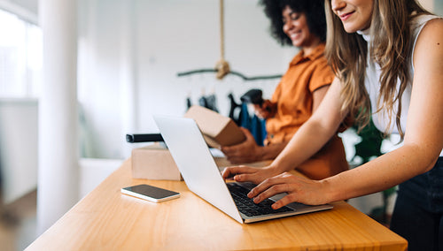 Two online business owners working together in their shop