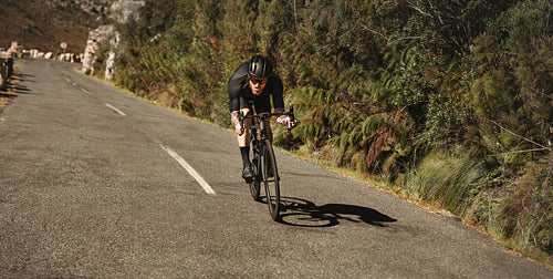 Sportsman going downhill fast on his bicycle.