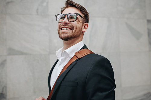 Close up of a smiling businessman looking away